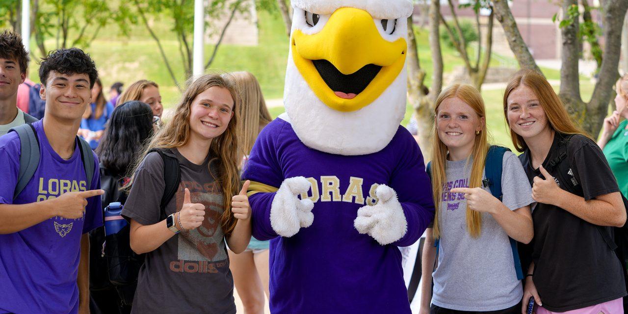 Students with mascot smiling and thumbs up