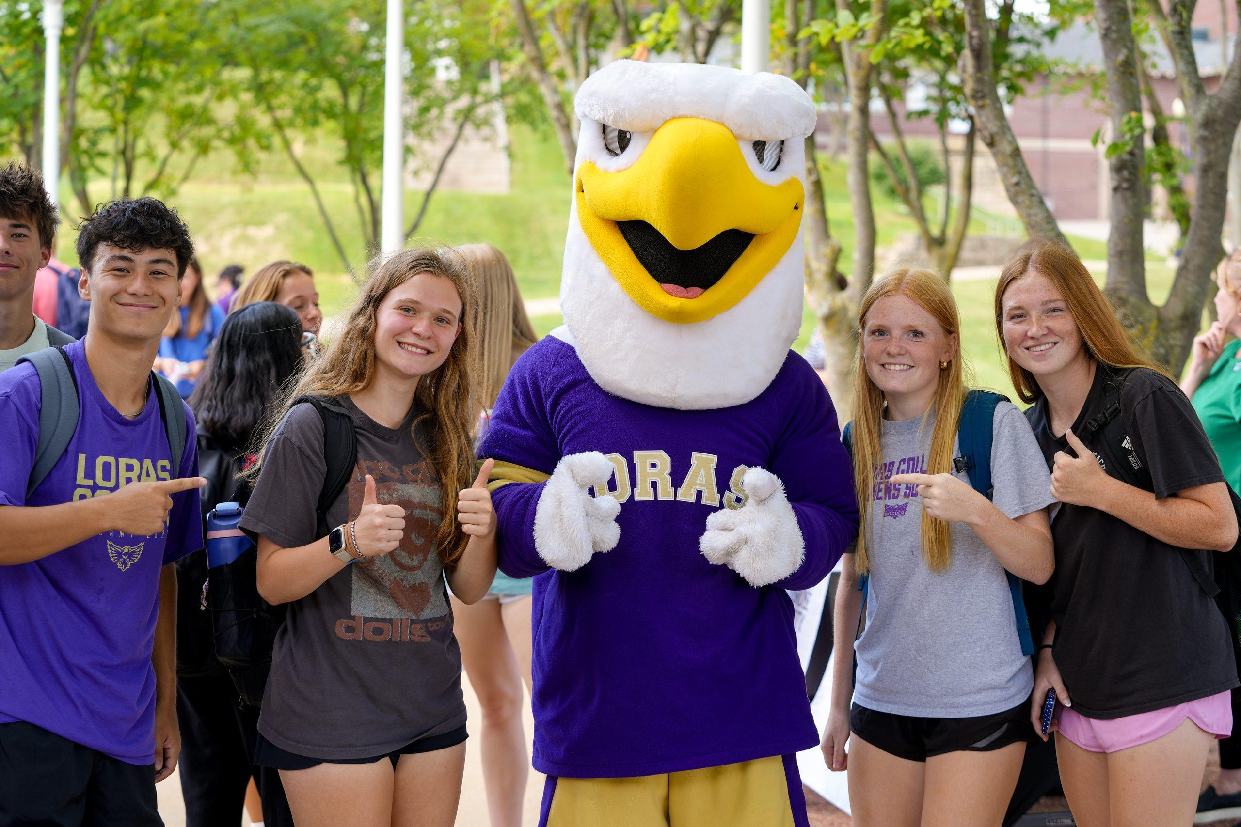 Students with mascot smiling and thumbs up