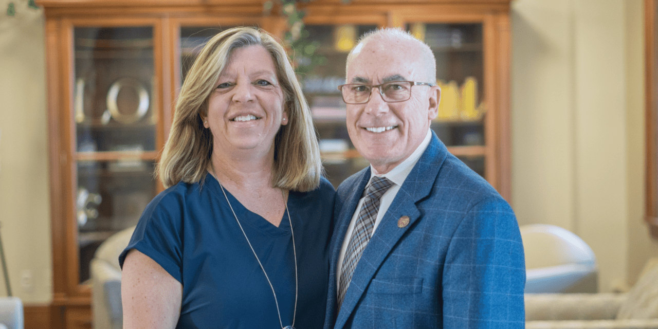 President Jim Collins and wife Lisa smiling