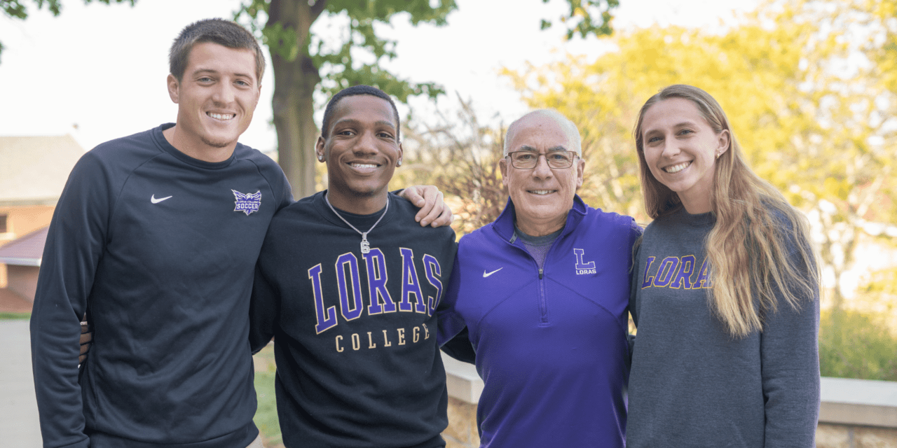Two male students and one female student with president smiling