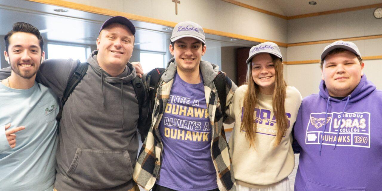 Five students smiling in loras clothing