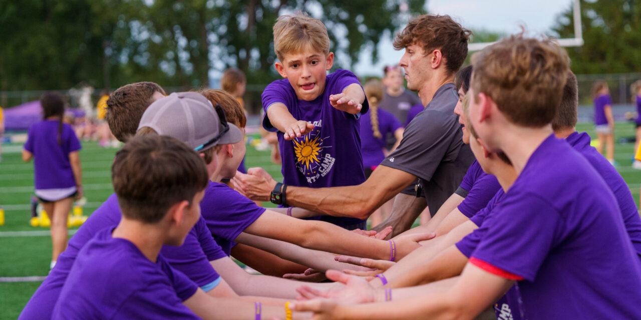 young men creating arm tunnel with one coming through