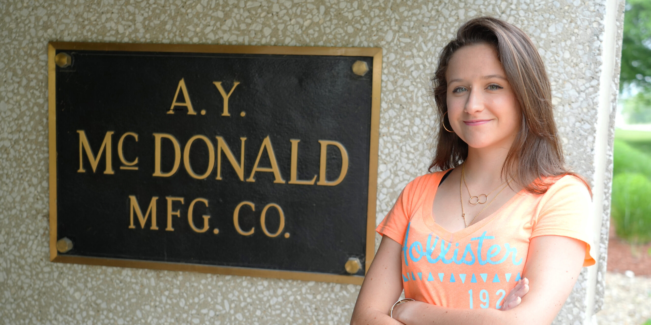Emilie Loras at her internship standing in front of A.Y. McDonald sign