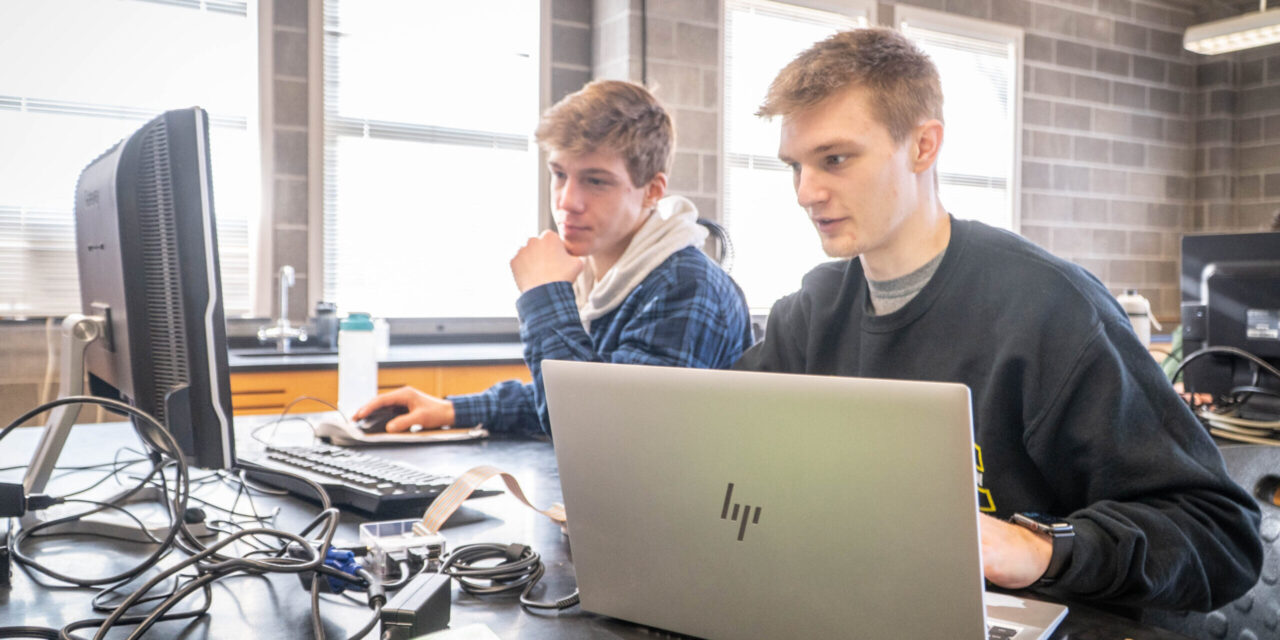 Two Engineering and computer science students working together on a project