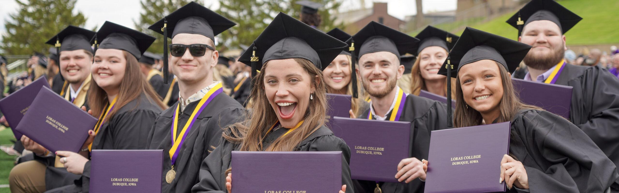 Grads with diplomas at Commencement