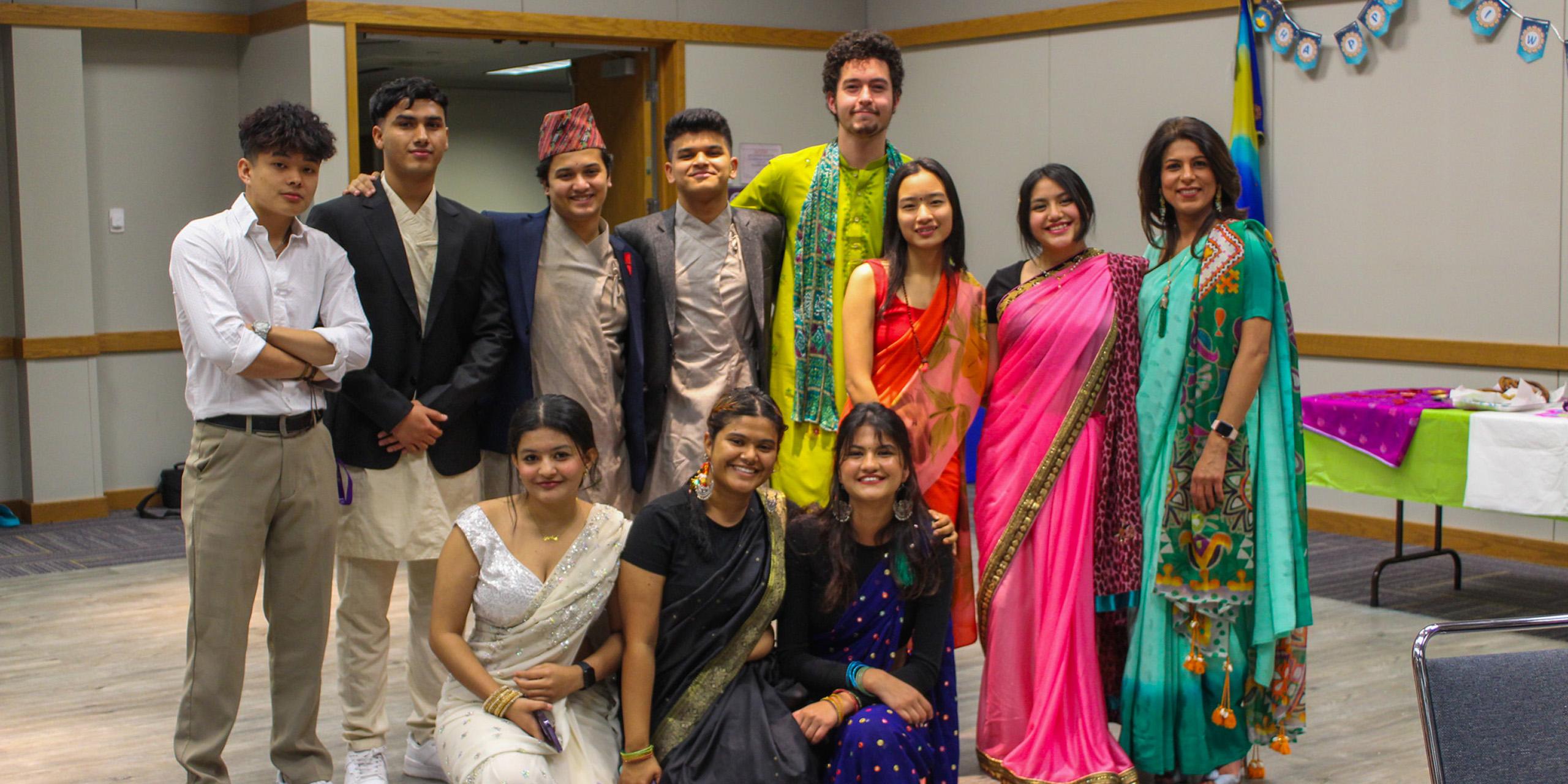 Group of students and faculty smiling for group photo at diwali event