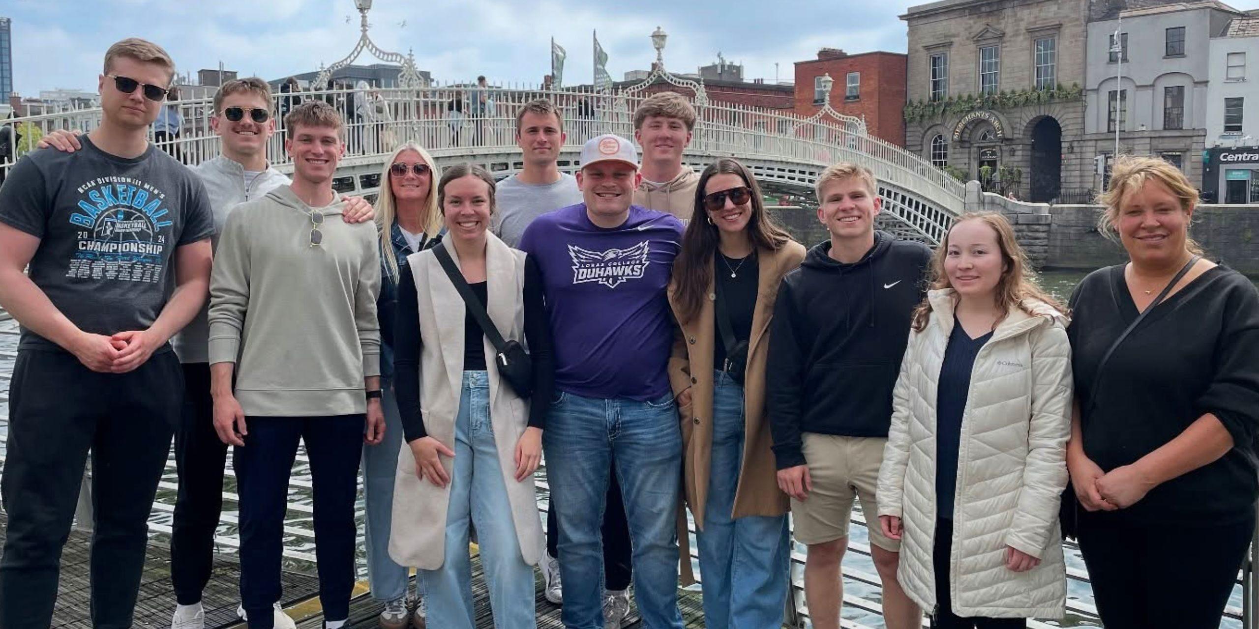 Students smiling by bridge