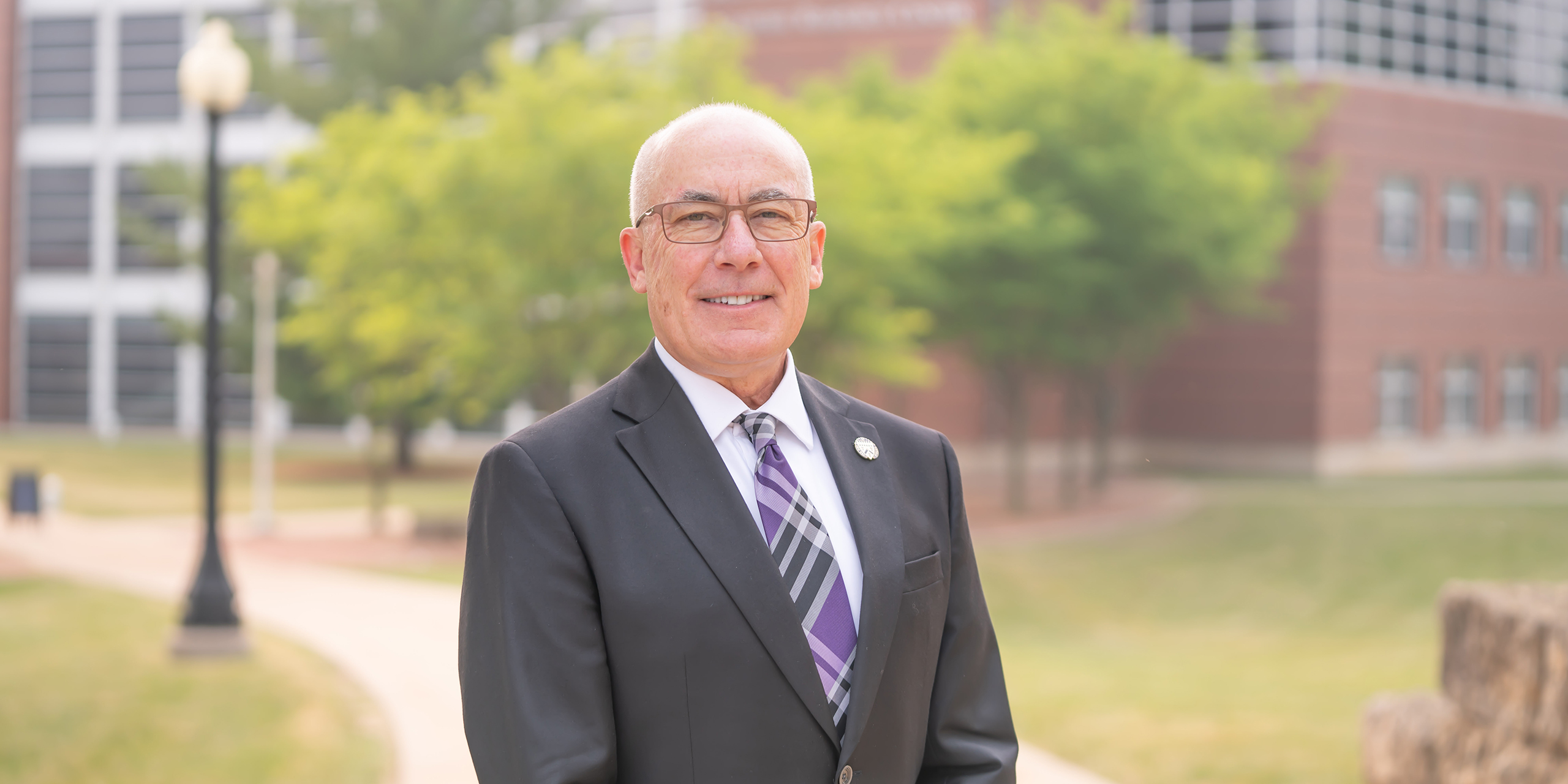 Loras President James Collins in front of Keane Hall