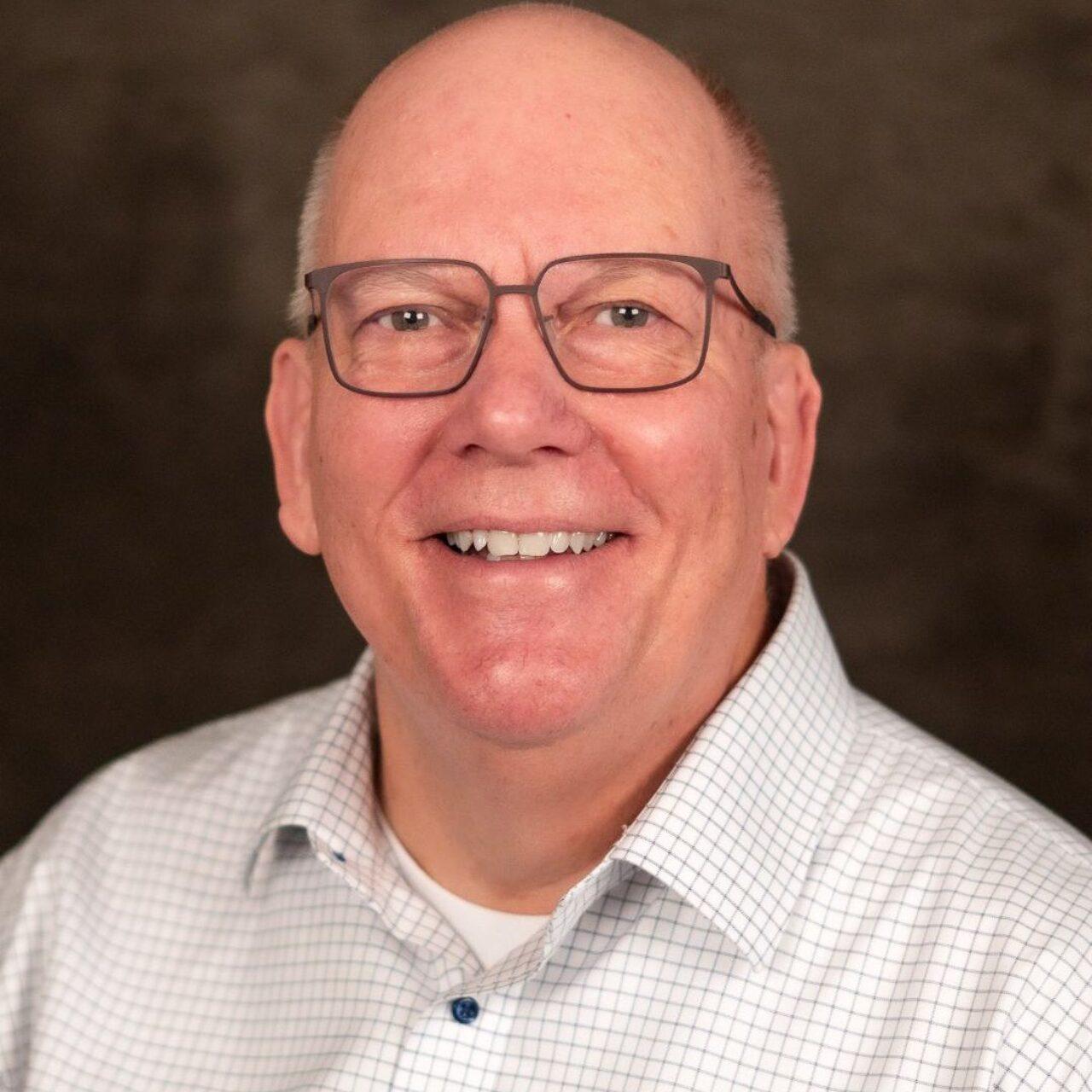 smiling adult in white button down shirtsmiling adult in white button down shirt