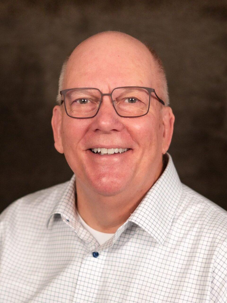 smiling adult in white button down shirtsmiling adult in white button down shirt