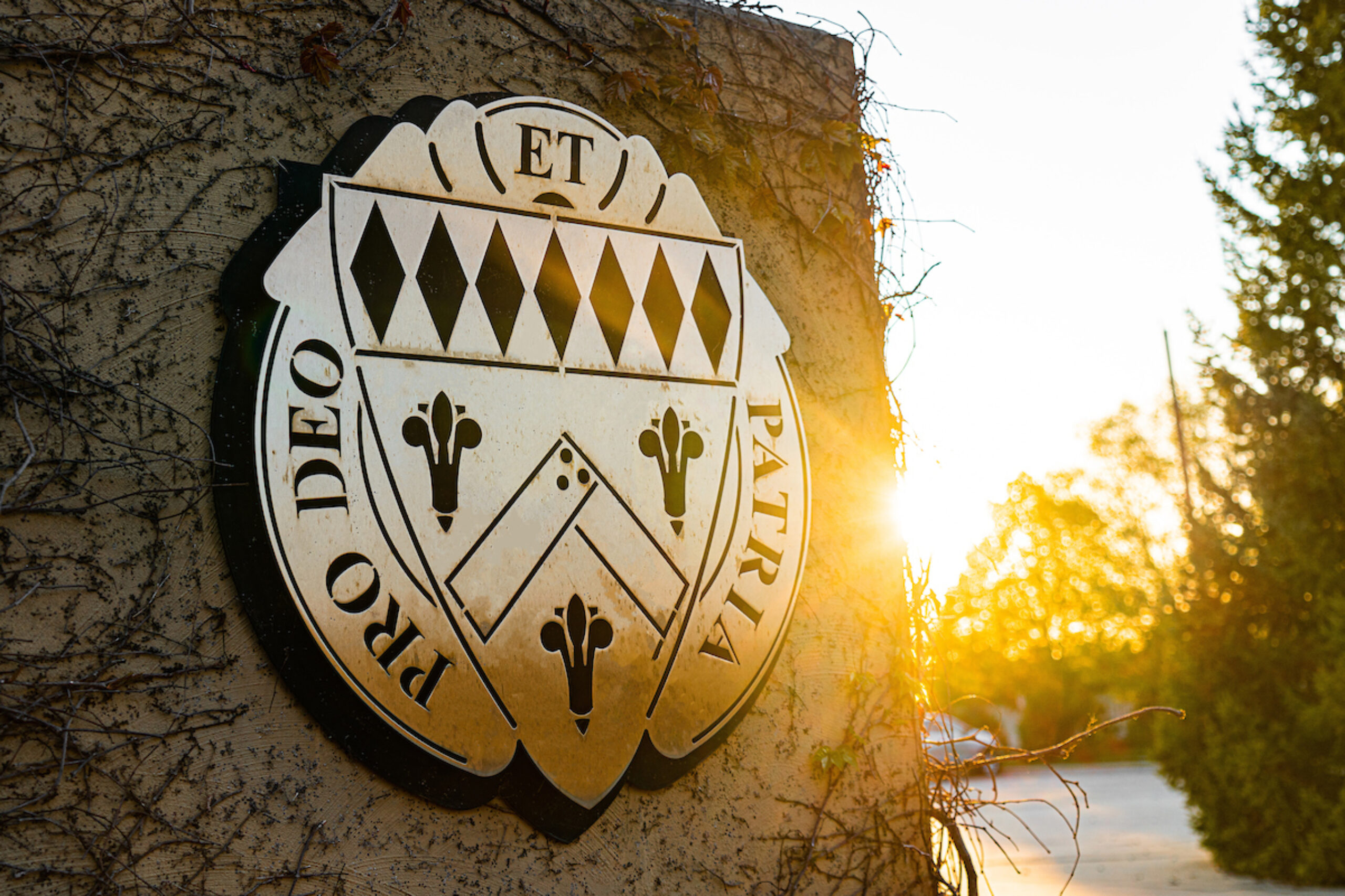 rock pillar with Loras metal crest sign with sunset behind