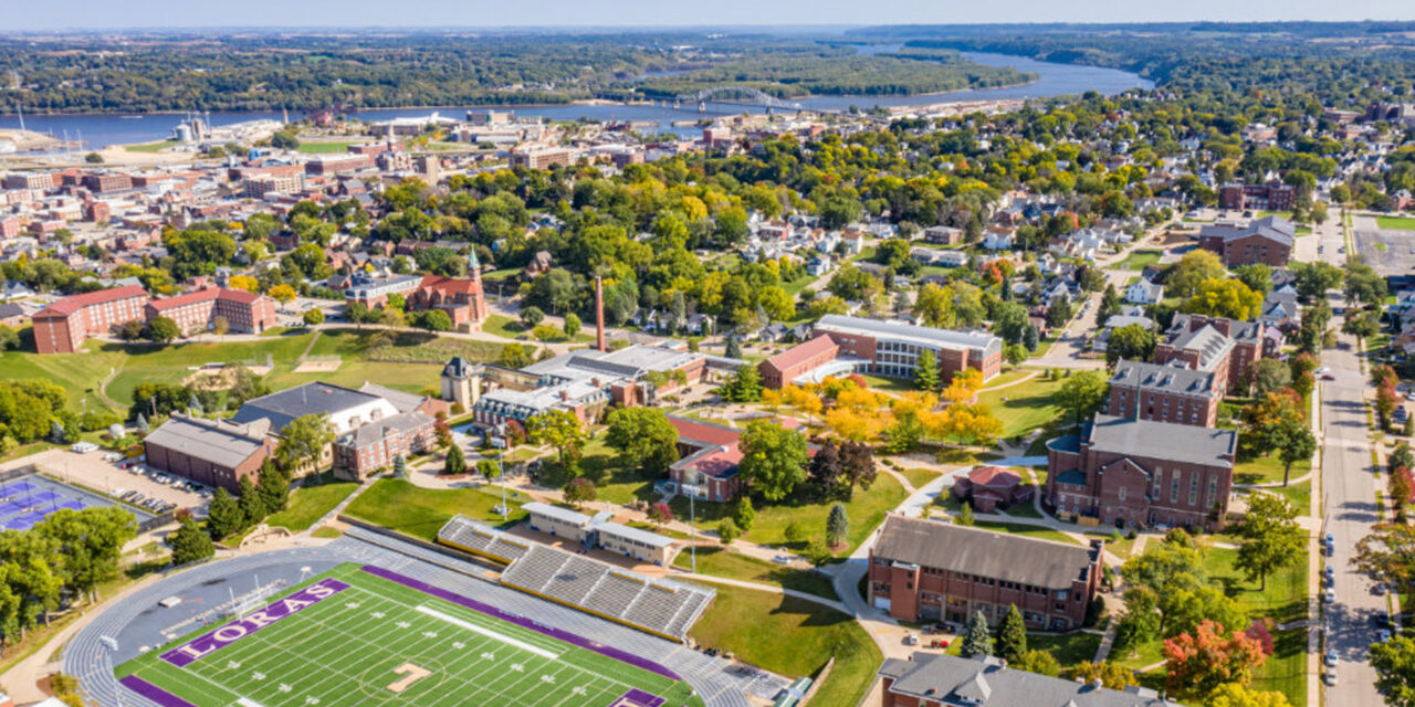 aerial view of campus with football stadium and campus buildings with Mississippi River in background