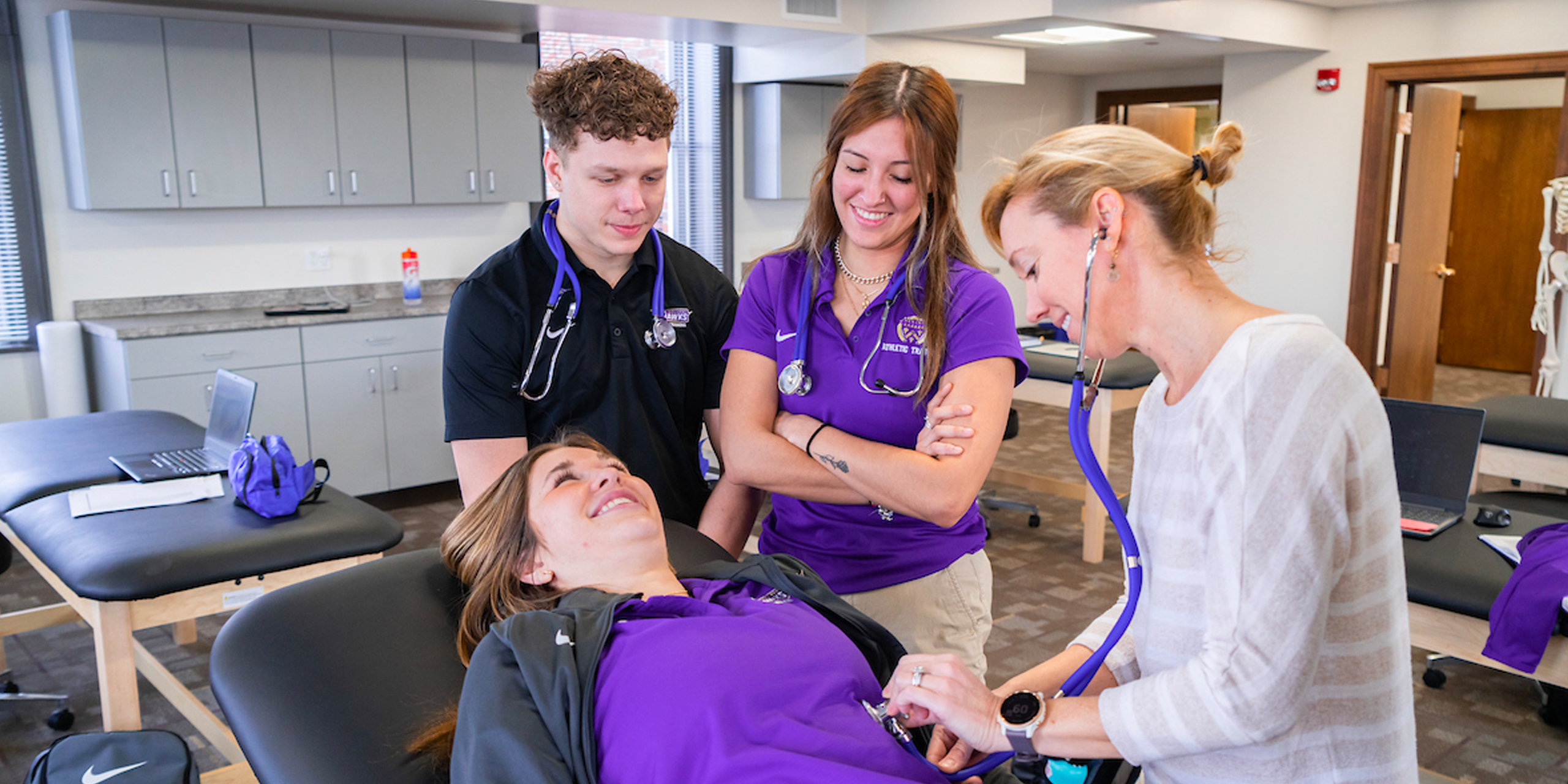 Students working with professor in Keane Hall 4th floor Health programs lab