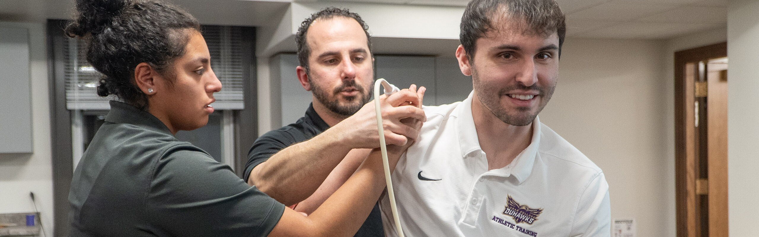 Athletic training students practicing skills in the lab