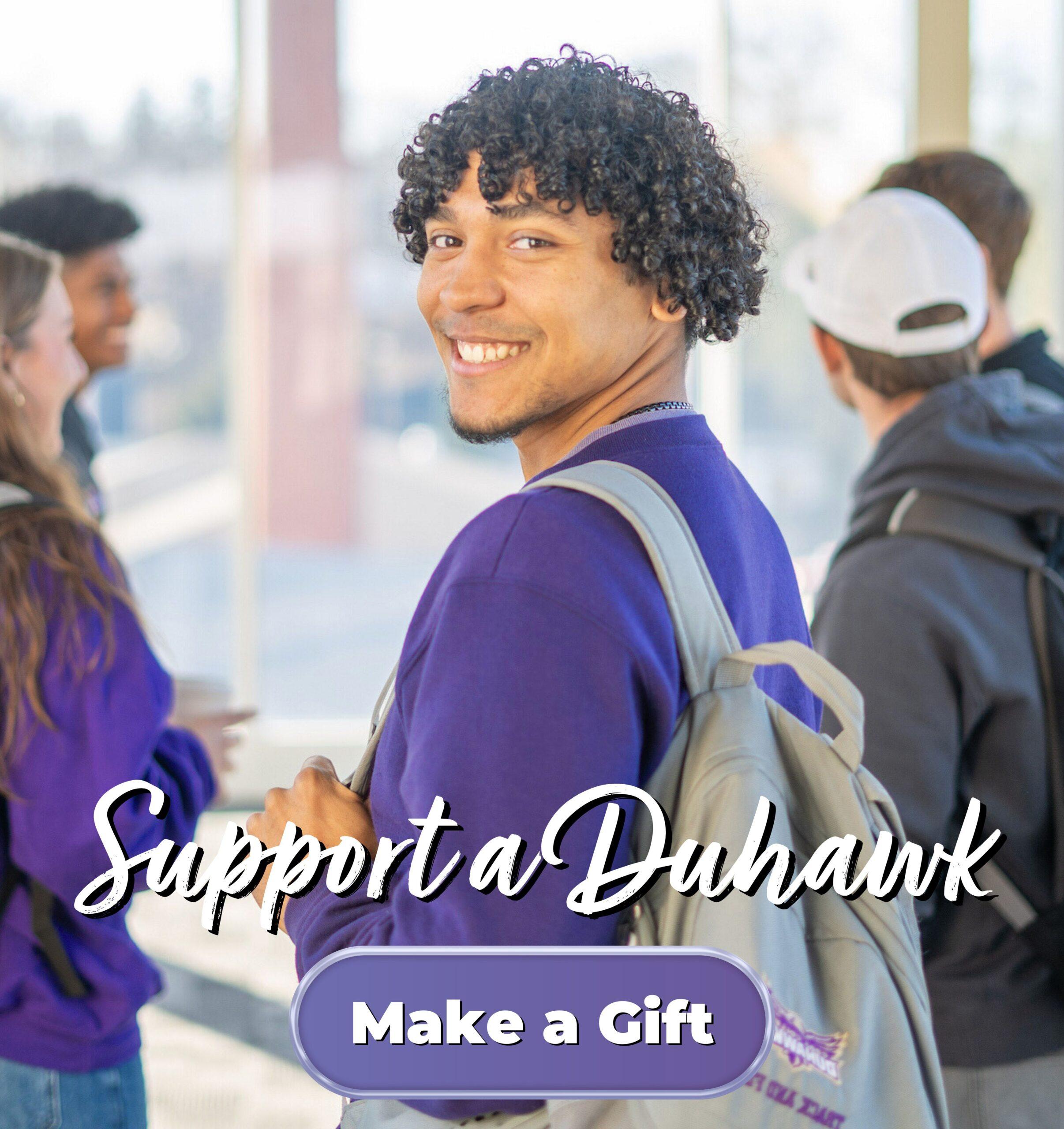 Male student looking over shoulder and smiling