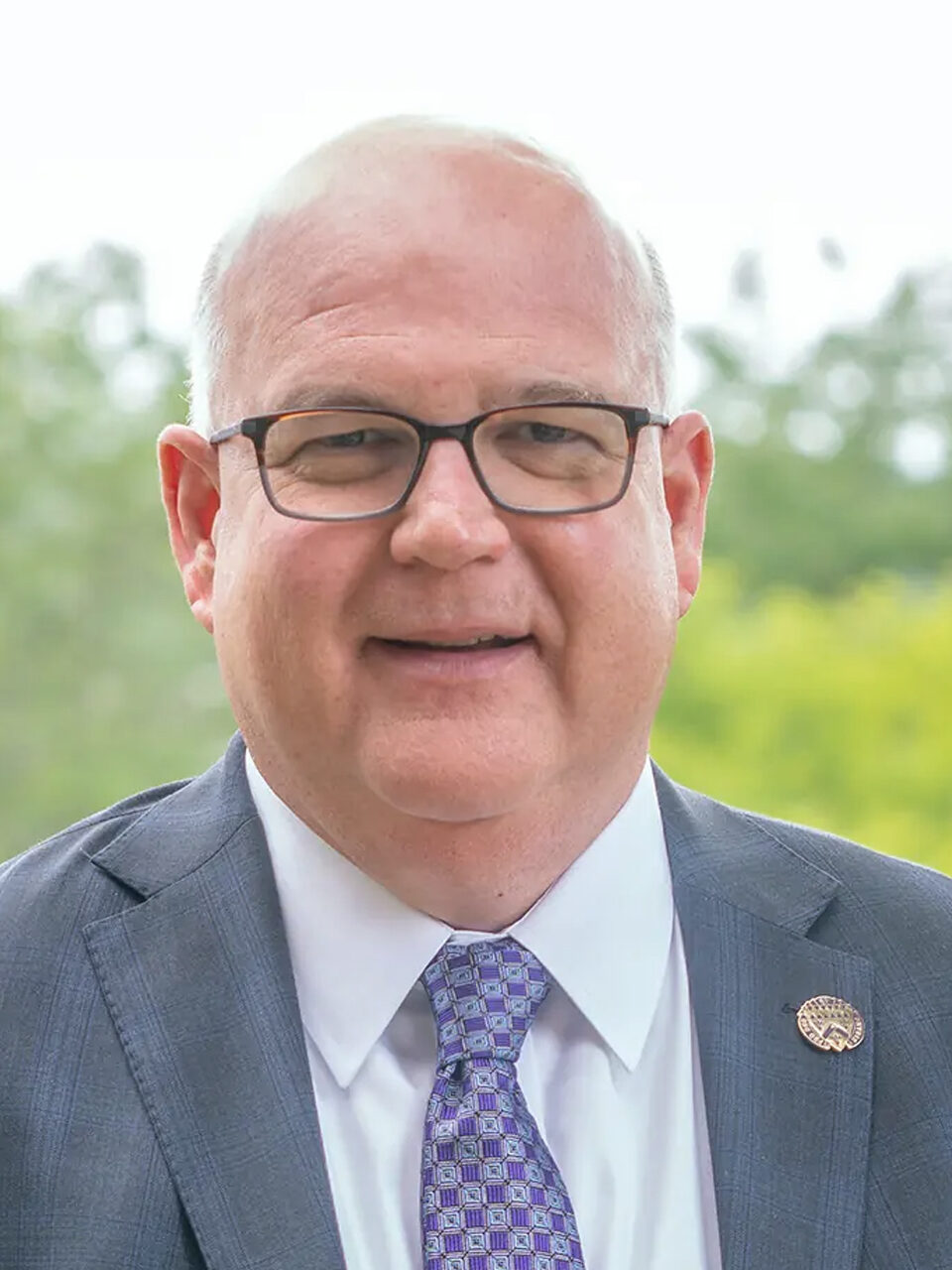 Alumnus and President-Elect Mike Doyle '91 with Loras College campus in the background