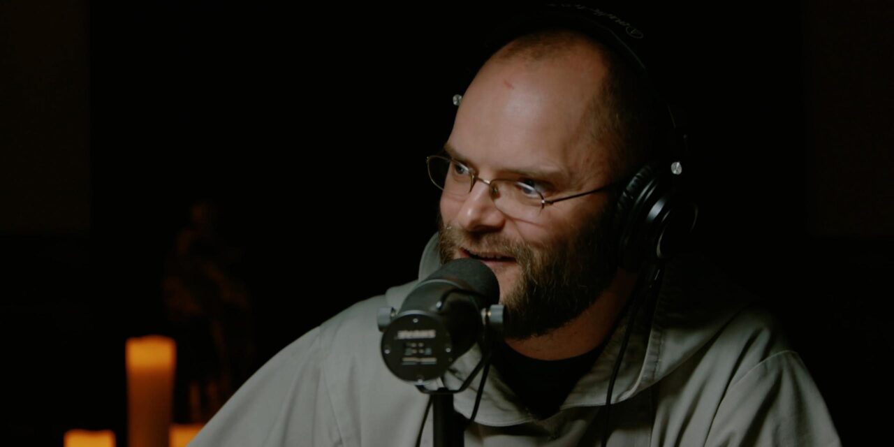 Fr. Angelus ('07), a Franciscan Friar of the Renewal in New York speaking into a microphone with a headset on