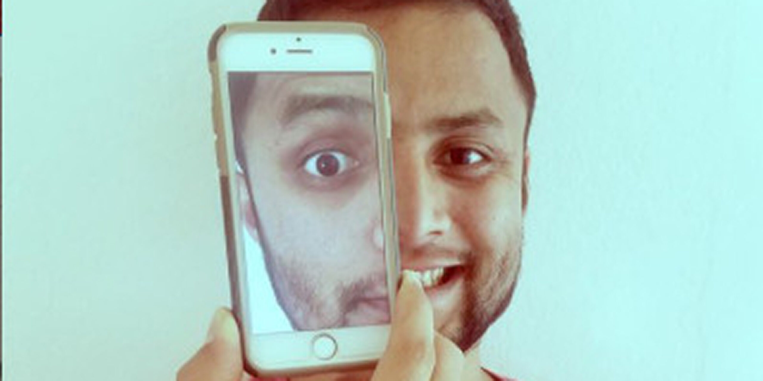 Rajendra "Raj" Thakurathi ('12) takes a picture with himself on his phone screen