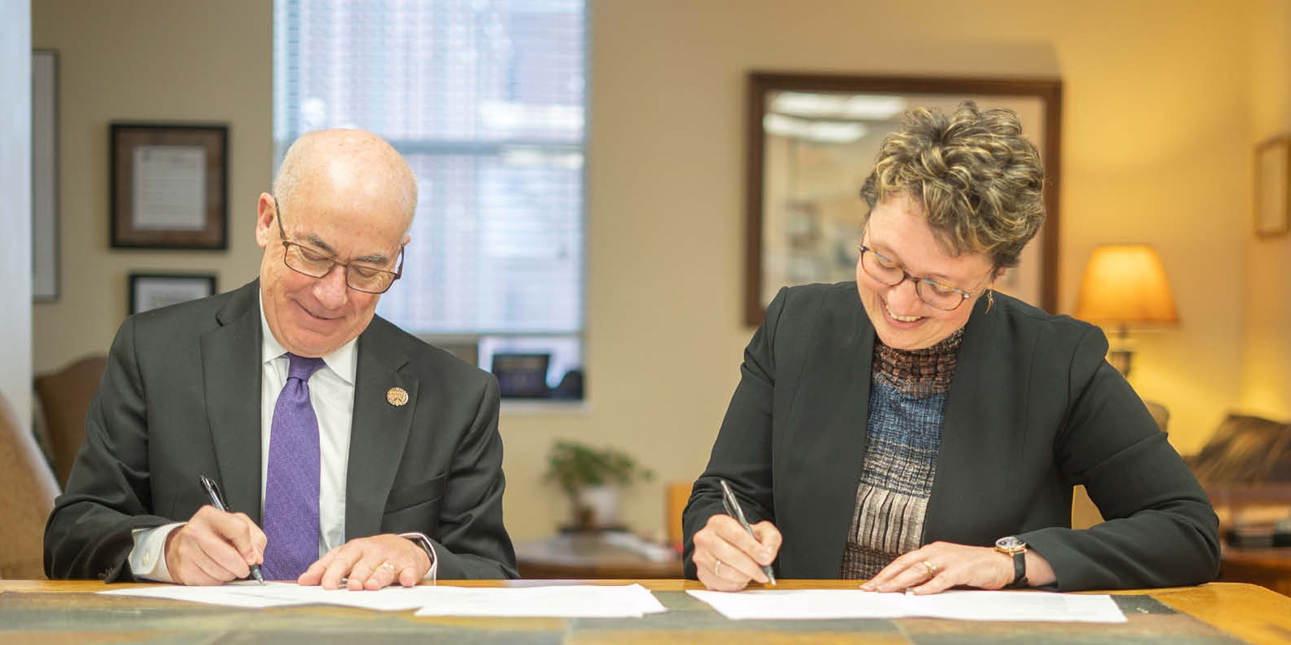 Loras College and SAU Presidents signing partnership agreement