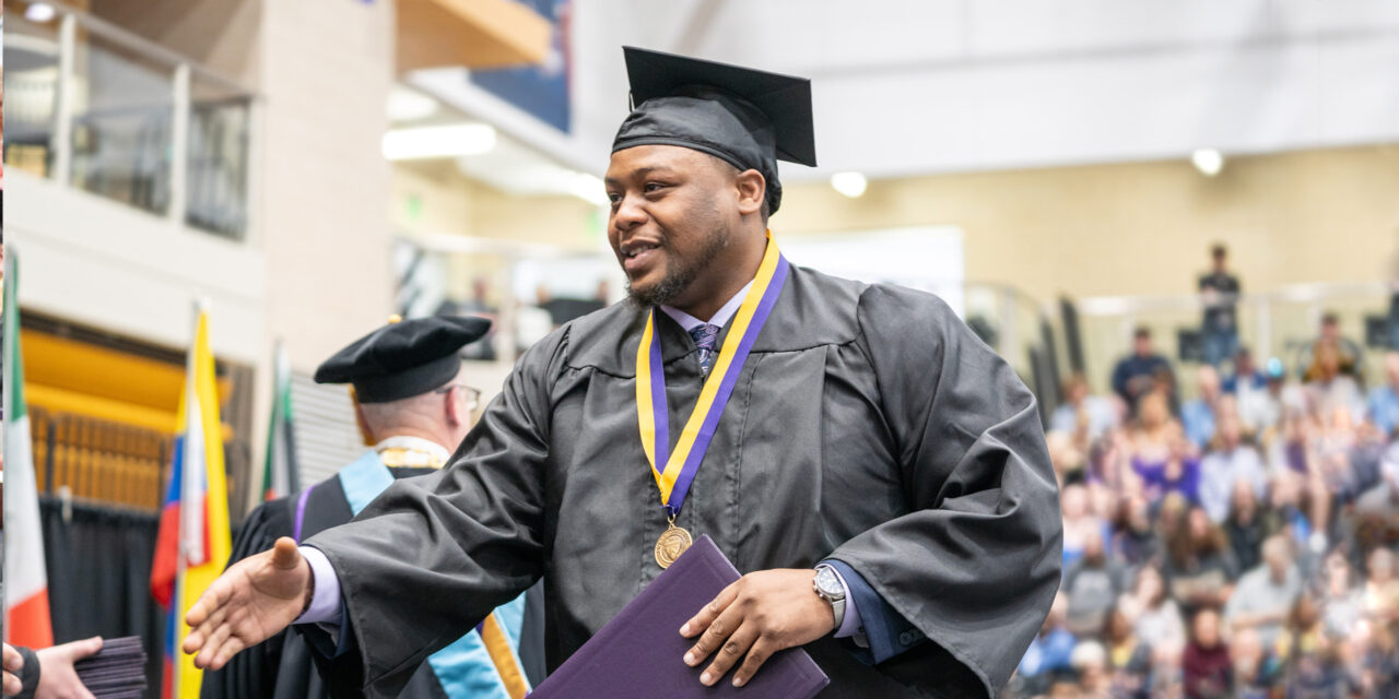 Loras student shaking hands with President Collins at Commencement Ceremony