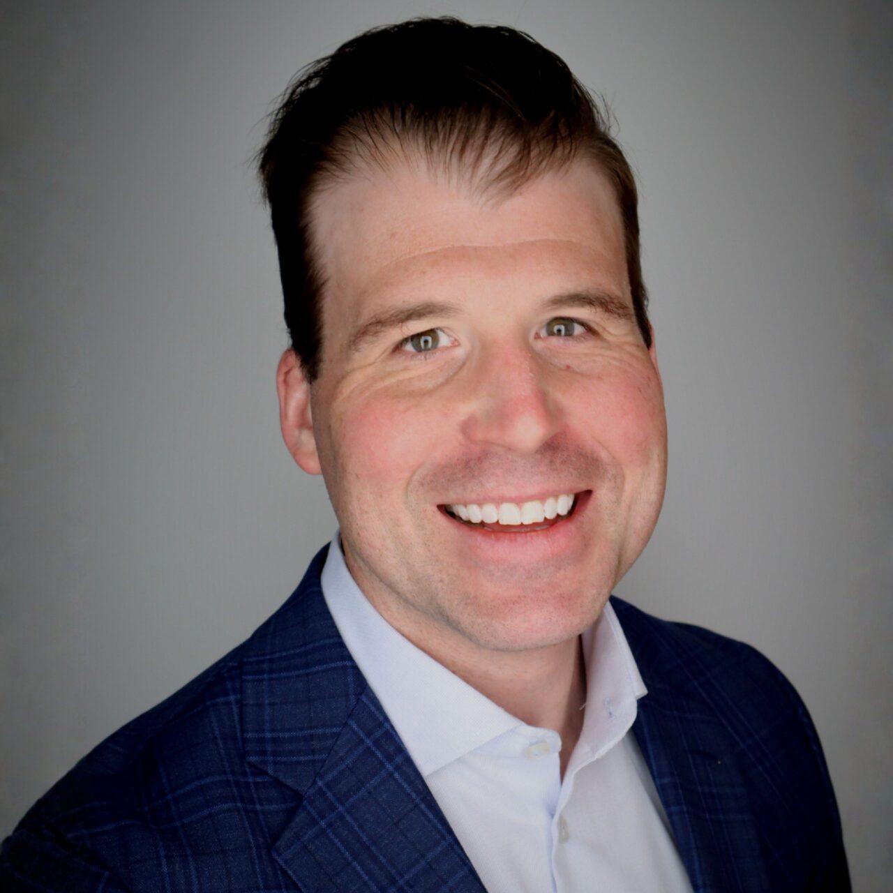 smiling man with white shirt and blue suit jacket