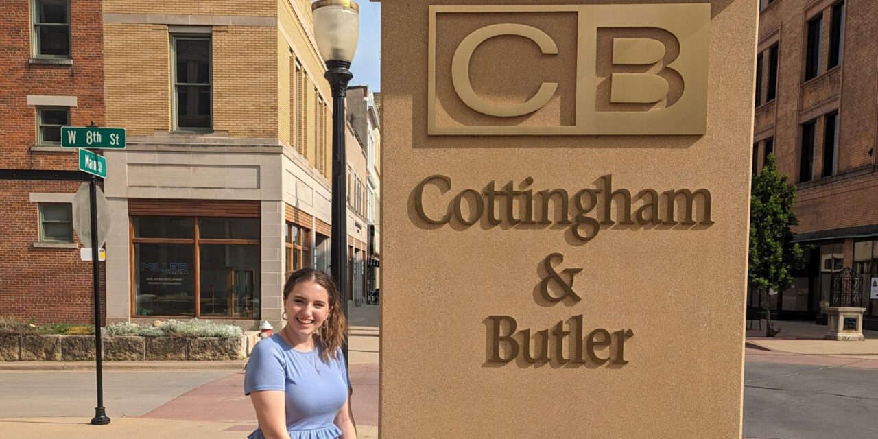 Celina Feldhake ('24) stands outside her internship at Cottingham & Butler in Dubuque, IA.
