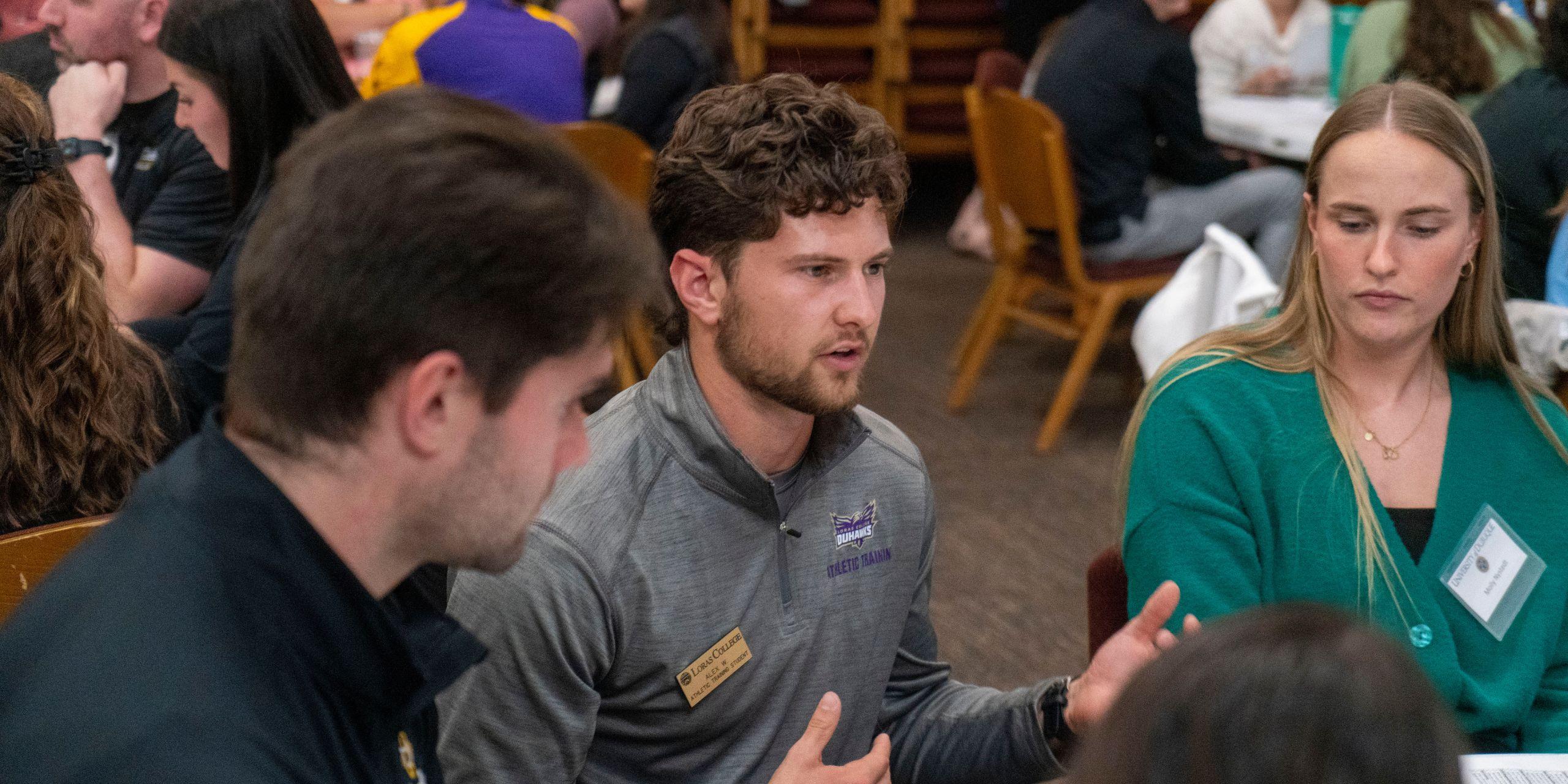 Students from Loras College, the University of Dubuque, and Clarke University converse at the Tri-College Interprofessional Education Event at Blades Hall.