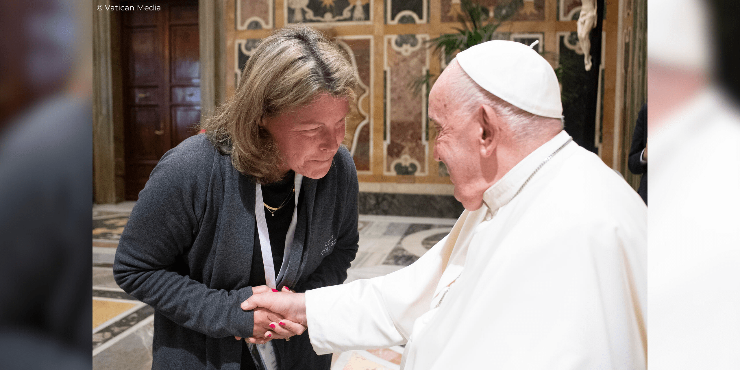 Nancy Z. Fett, professor of social work at Loras College, shakes Pope Francis' hand at the Vatican.