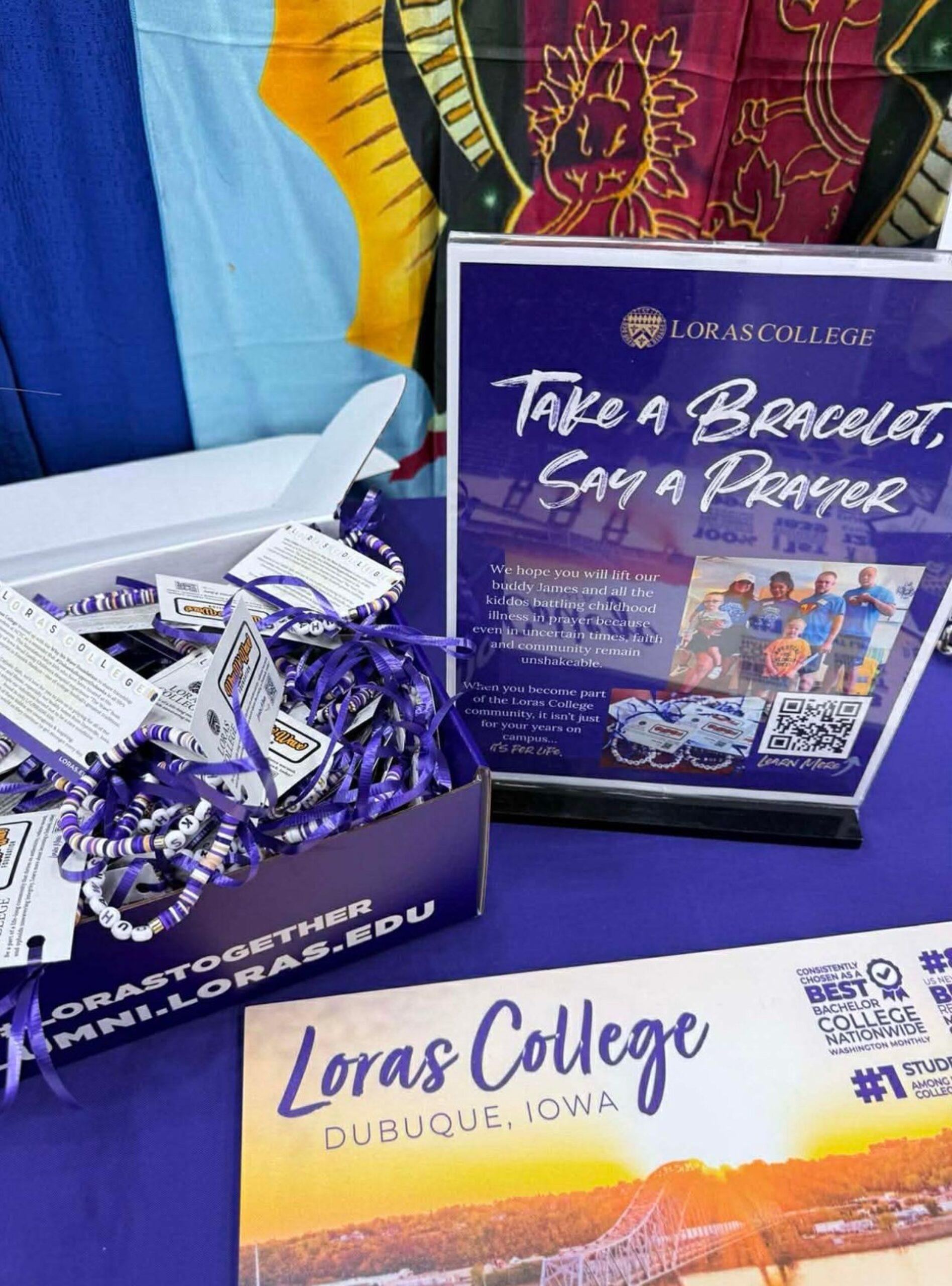 purple and gold beaded bracelets with purple sign with white writing.