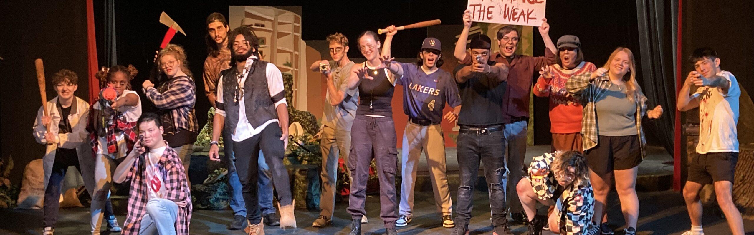 A group of students on stage performing a production about Zombies