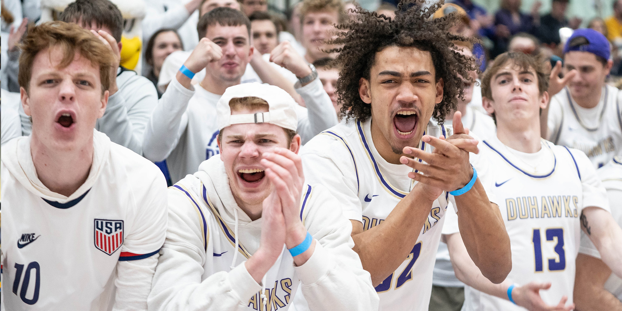 Loras College Basketball players supporting each other during a game