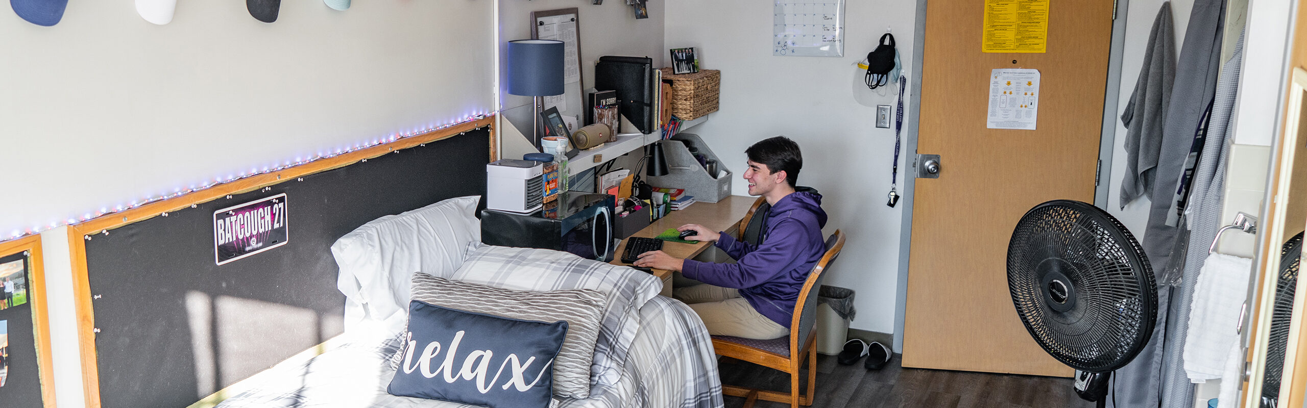 Student at their desk studying in their residence hall room